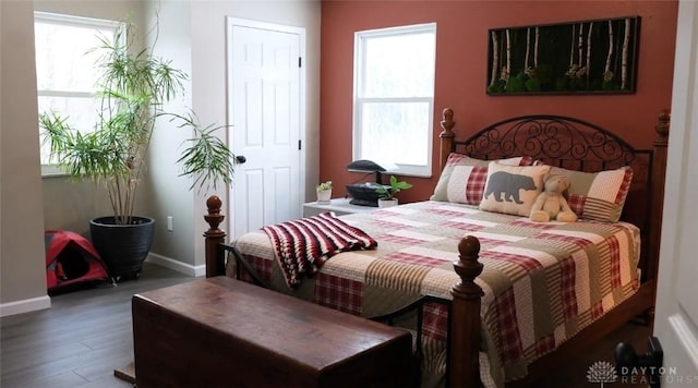 bedroom with dark hardwood / wood-style floors