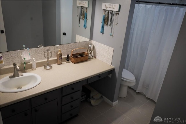 bathroom with tile patterned flooring, vanity, and toilet