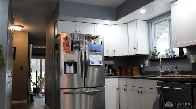 kitchen featuring sink, white cabinets, and stainless steel refrigerator with ice dispenser