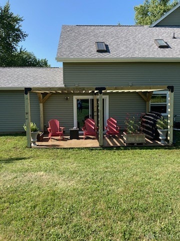 rear view of property featuring a patio and a yard