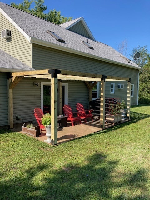 back of house with a lawn, a patio, and a wall mounted AC