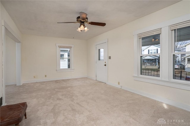 entrance foyer featuring light colored carpet and ceiling fan