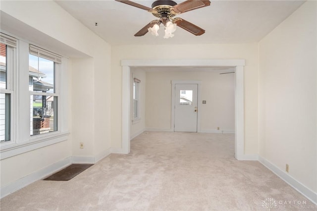 foyer with light colored carpet and ceiling fan