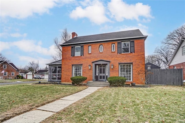 colonial-style house with a front lawn