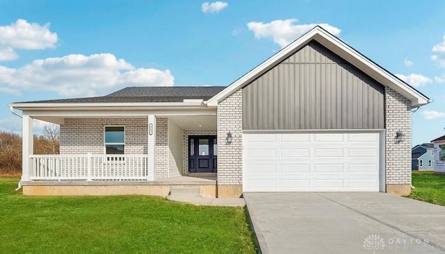 view of front facade featuring a garage, covered porch, and a front lawn