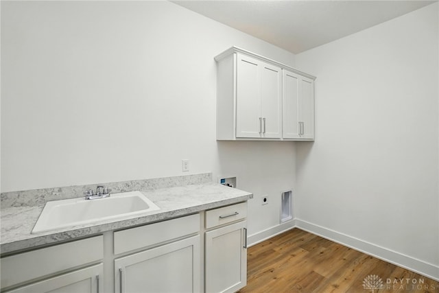 300 Grassy Creek Way, Washington Twp, OH 45458 - washroom with hookup for an electric dryer, washer hookup, cabinet space, light wood finished floors, and baseboards