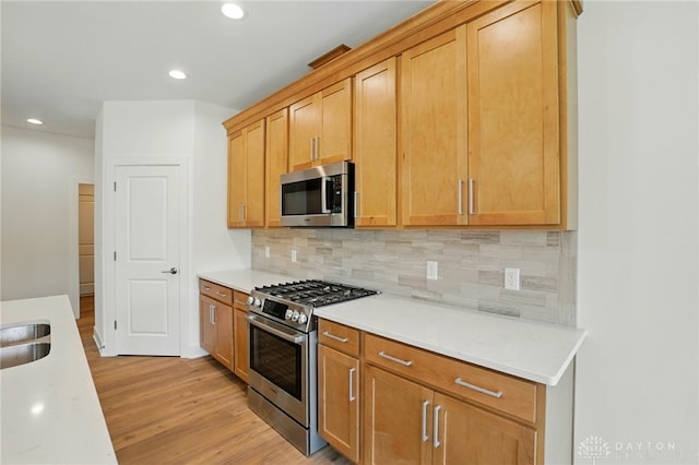 300 Grassy Creek Way, Washington Twp, OH 45458 - kitchen with stainless steel appliances, light wood-style flooring, light countertops, recessed lighting, and backsplash