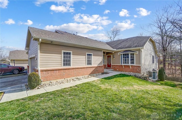 ranch-style house with a garage, cooling unit, and a front lawn