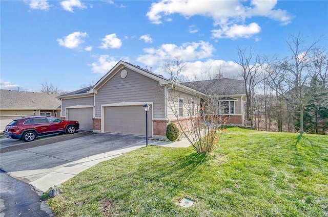 single story home with a garage and a front lawn