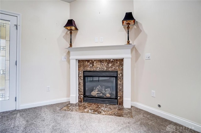 room details featuring a fireplace and carpet