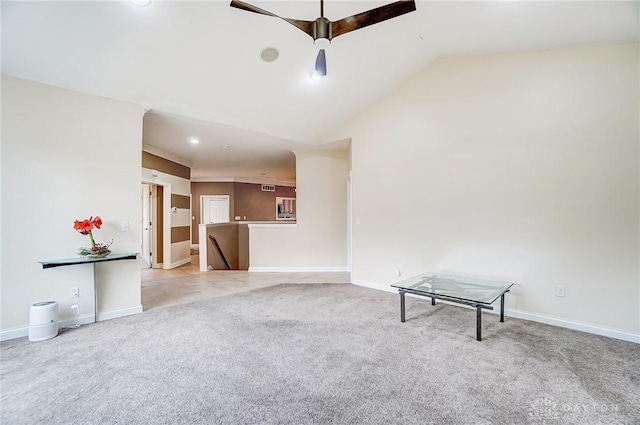 unfurnished living room with vaulted ceiling and light colored carpet