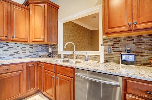 kitchen featuring sink, backsplash, ornamental molding, stainless steel dishwasher, and light stone countertops