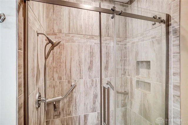 interior details featuring a shower with door