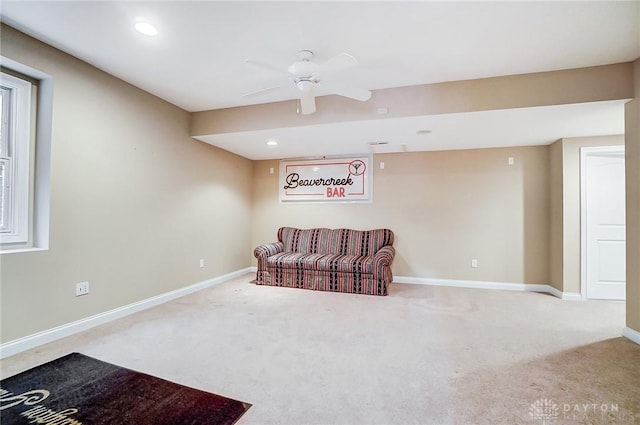 sitting room with carpet and ceiling fan