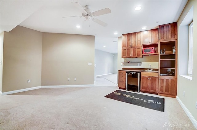 kitchen featuring ceiling fan, dishwasher, sink, and light carpet