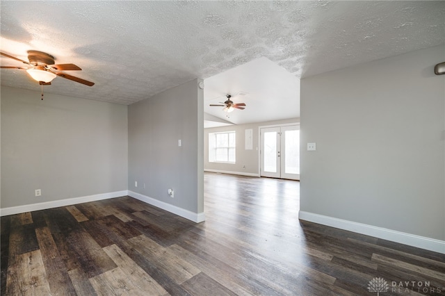 spare room with lofted ceiling, ceiling fan, a textured ceiling, dark hardwood / wood-style flooring, and french doors