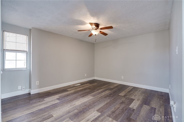 unfurnished room with dark hardwood / wood-style floors, a textured ceiling, and ceiling fan