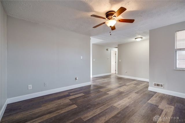 spare room with ceiling fan, dark hardwood / wood-style flooring, and a textured ceiling