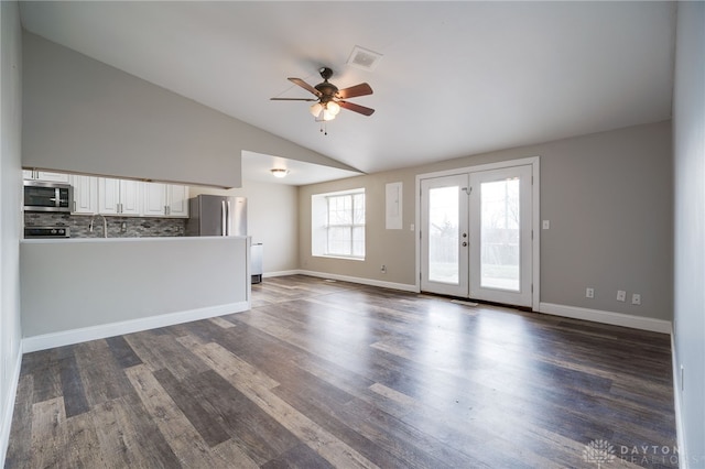 unfurnished living room featuring french doors, lofted ceiling, sink, dark hardwood / wood-style flooring, and ceiling fan