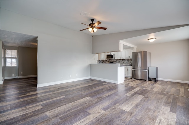 unfurnished living room with lofted ceiling, dark hardwood / wood-style floors, and ceiling fan