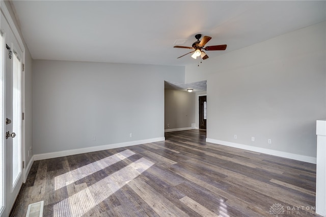 spare room featuring ceiling fan, vaulted ceiling, and dark hardwood / wood-style flooring