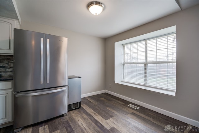 kitchen with tasteful backsplash, stainless steel fridge, and dark hardwood / wood-style flooring