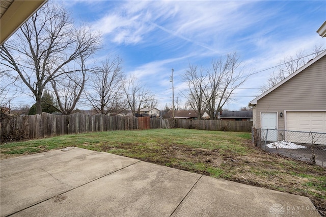 view of yard with a garage and a patio area