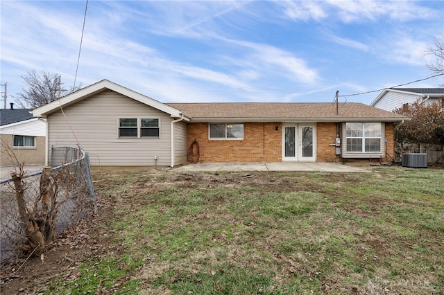 rear view of house featuring a lawn, a patio area, and central air condition unit