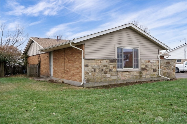 view of home's exterior with a yard