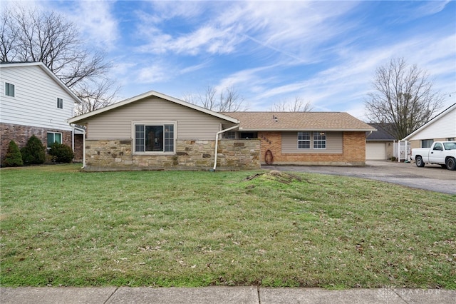 view of front of house with a garage and a front lawn