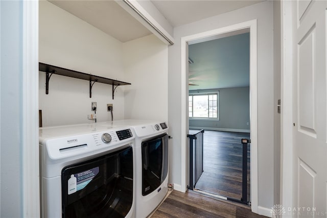 laundry area featuring dark hardwood / wood-style floors and washing machine and dryer