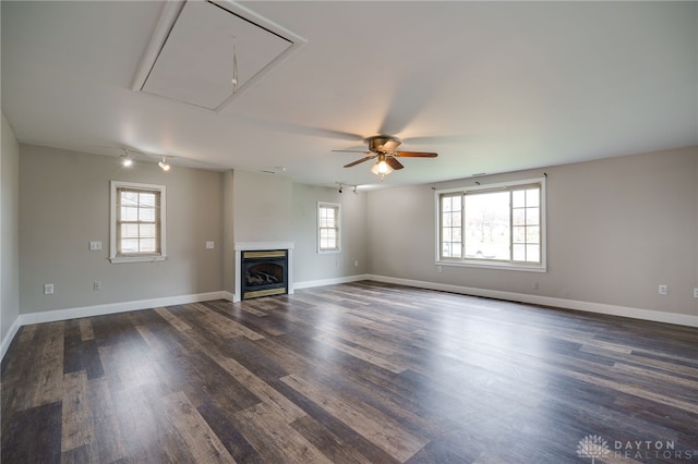 unfurnished living room featuring dark hardwood / wood-style flooring and ceiling fan