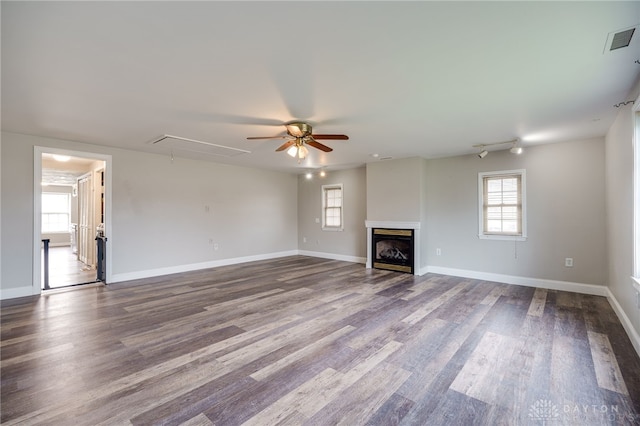 unfurnished living room with ceiling fan, plenty of natural light, and hardwood / wood-style floors