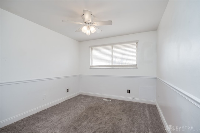 spare room featuring carpet flooring and ceiling fan