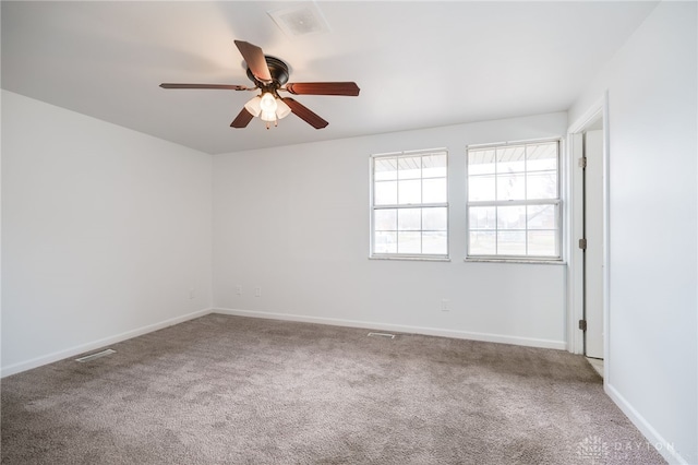 carpeted spare room featuring ceiling fan