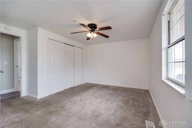 unfurnished bedroom with carpet, ceiling fan, and a closet