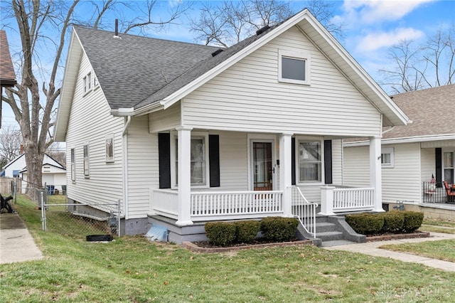 bungalow-style house with a porch and a front lawn