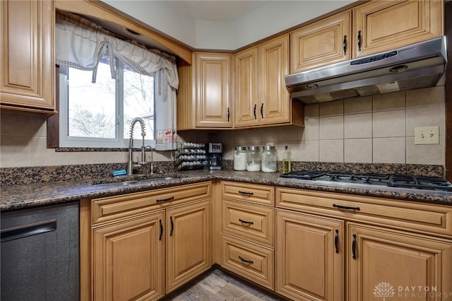 kitchen featuring stainless steel gas cooktop, sink, dishwasher, dark stone counters, and backsplash