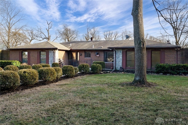 ranch-style home with a front lawn