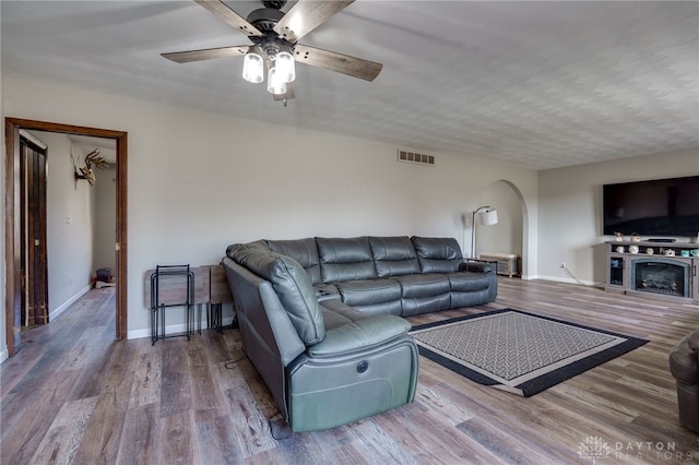 living room with ceiling fan and hardwood / wood-style floors