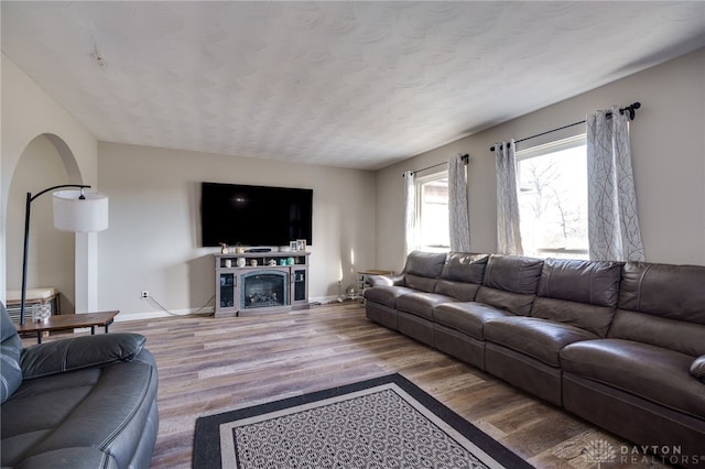 living room featuring a textured ceiling and light wood-type flooring