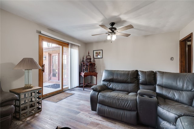 living room featuring ceiling fan and light wood-type flooring