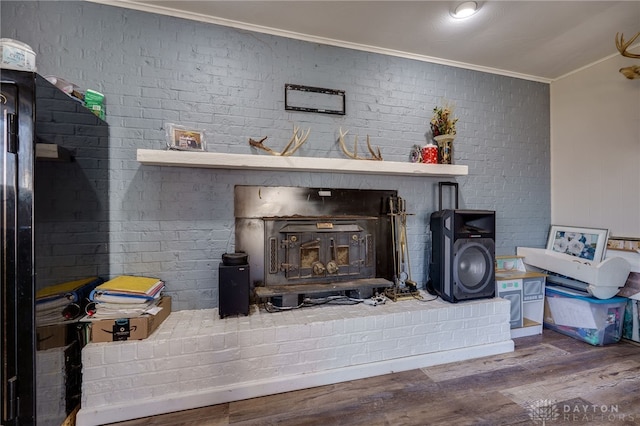 room details featuring hardwood / wood-style flooring, crown molding, and a wood stove