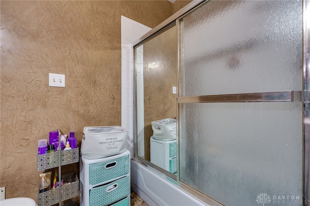 bathroom with bath / shower combo with glass door