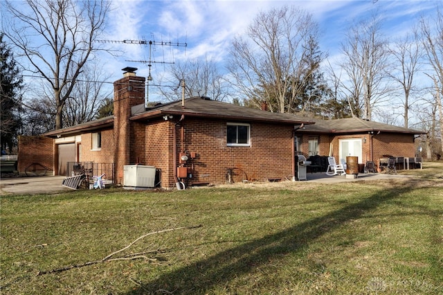 rear view of property featuring a patio area and a lawn