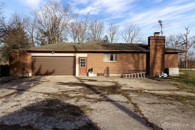 rear view of property featuring a garage