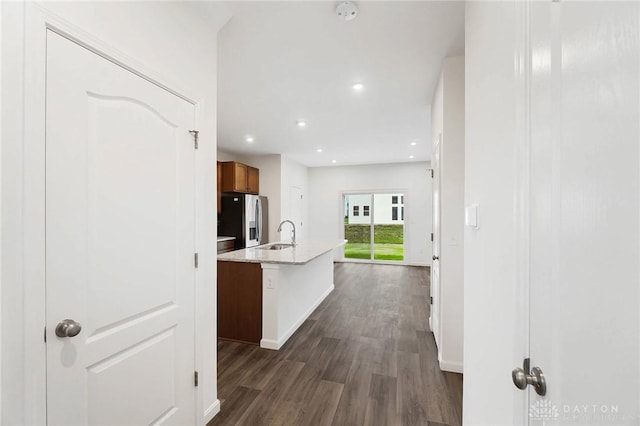 hall with sink and dark wood-type flooring