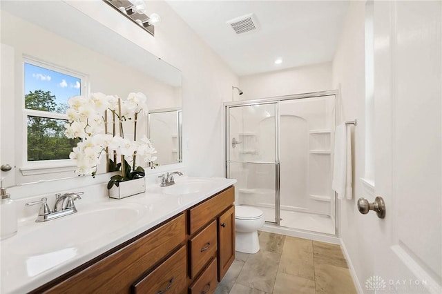 bathroom with vanity, an enclosed shower, and toilet