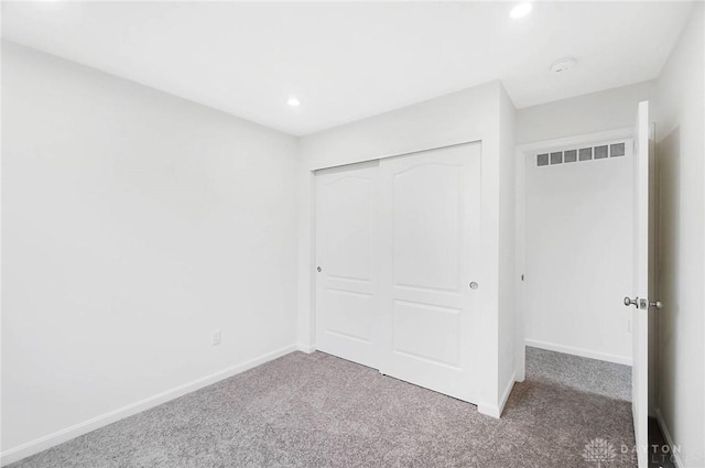 unfurnished bedroom featuring carpet flooring and a closet