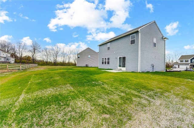 rear view of property featuring a lawn